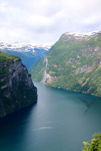 Scenic view of river amidst mountains against sky