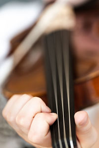 Cropped hand playing violin