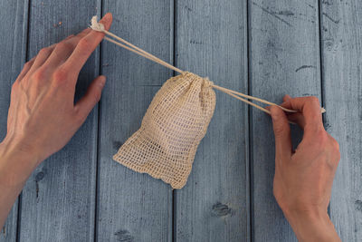 Woman hands open eco bag with reusable cotton pad for make-up remover. sustainable concept.