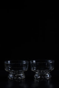 Close-up of glass bowls against black background