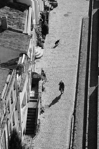 High angle view of people walking on street amidst buildings