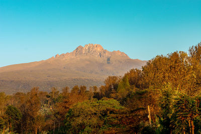 Scenic view of mountains against clear blue sky