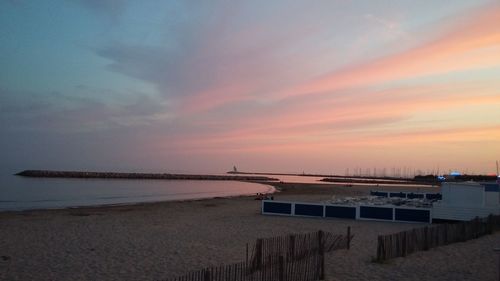 Scenic view of beach against dramatic sky