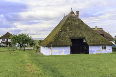 Built structure on field against sky