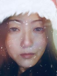 Close-up portrait of woman in snow