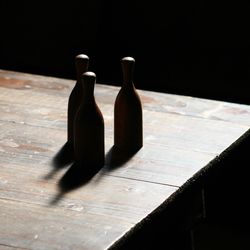 Close-up of wooden table against black background