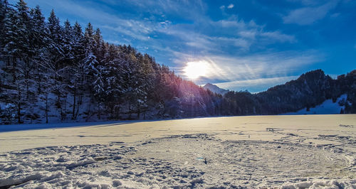 Scenic view of snow covered landscape against sky