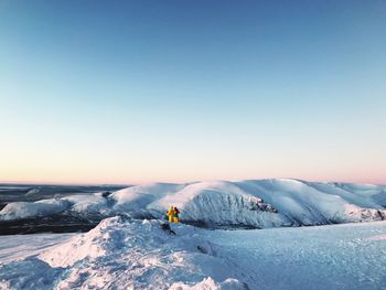 Scenic view of snow covered landscape against clear sky