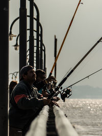 People fishing against sky