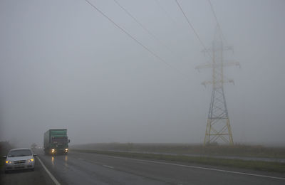 Cars on road against clear sky