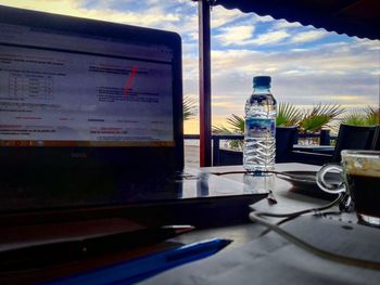Telephone booth on table against sky