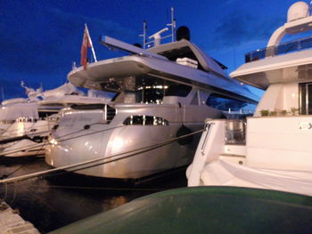 Airplane moored at airport against sky