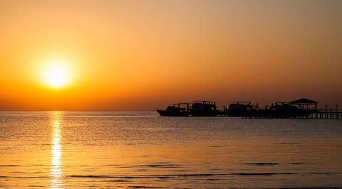 Scenic view of sea against orange sky