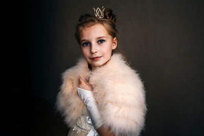 Portrait of girl against black background