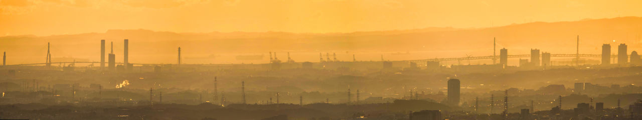 High angle view of buildings in city during sunset