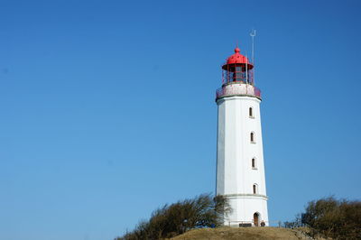 Low angle view of lighthouse against clear blue sky