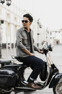 Young man sitting on motorcycle
