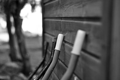 Close-up of  wheelbarrow against wall