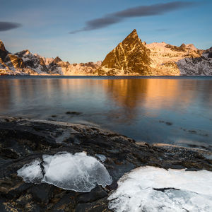 Scenic view of frozen lake against sky during winter