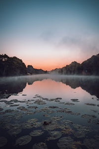 Scenic view of lake against sky during sunset