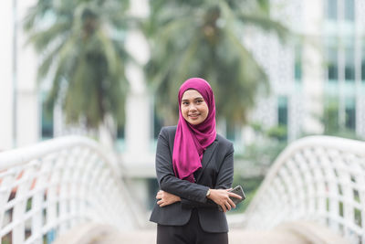 Young woman wearing mask standing in city