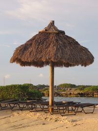 Gazebo on beach against sky