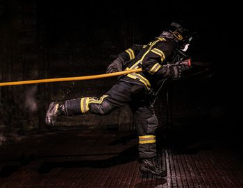 Midsection of man using smart phone at night