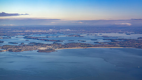 Aerial view of sea against sky during sunset