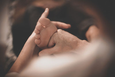 Close-up of mother holding baby hand