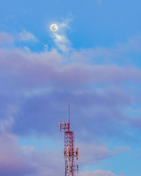 Low angle view of communications tower against sky