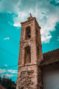 Low angle view of old building against blue sky