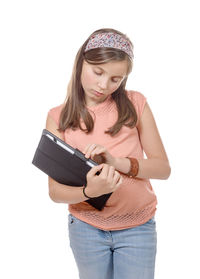 Teenage girl holding file against white background