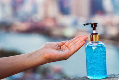 Close-up of hand holding water bottle