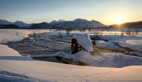 Scenic view of landscape against clear sky during sunset