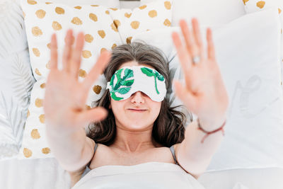 Portrait of woman lying down on bed