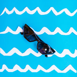 Close-up of sunglasses on swimming pool