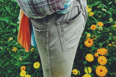 Low section of woman standing on flower