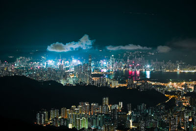 Illuminated cityscape against sky at night