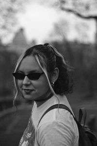 Portrait of woman wearing sunglasses while standing outdoors