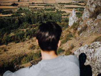 Rear view of man looking at camera