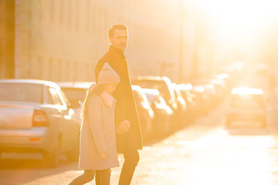 Full length of woman standing on street in city