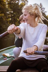 Woman looking away while sitting in boat