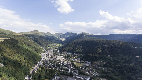 Village in valley at le mont-dore against sky