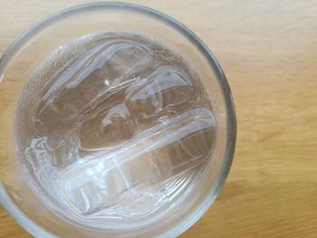 Directly above shot of ice glass on table