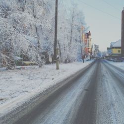 Empty road along buildings