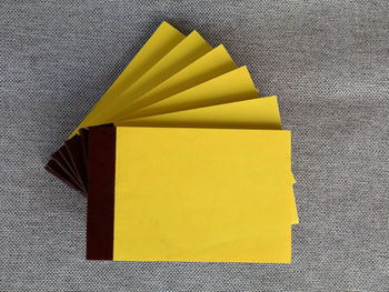 High angle view of yellow paper on table