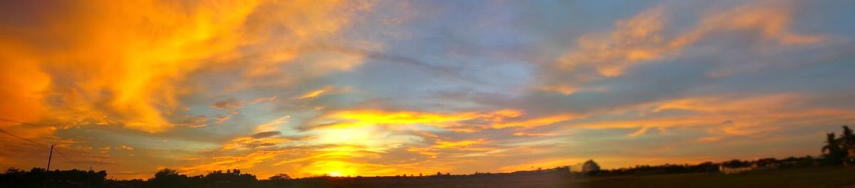 Scenic view of landscape against sky at sunset