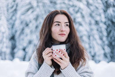 Portrait of young woman using mobile phone