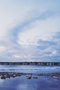 Bridge over sea against sky