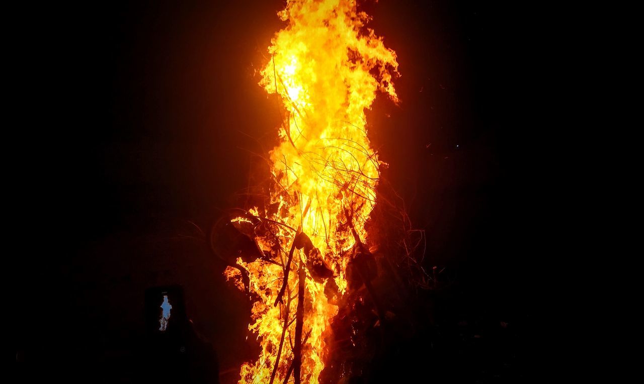 CLOSE-UP OF FIRE AGAINST DARK SKY